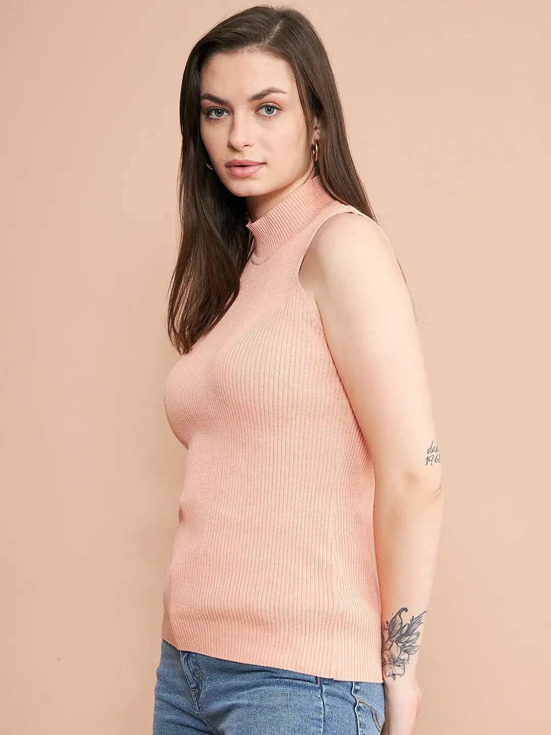 Woman with long brown hair in a 98degreenorth dark pink ribbed high neck slim fit knit tank, showing her arm tattoo.