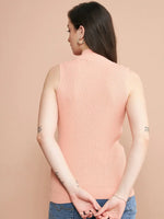 Woman facing away in 98degreenorth Dark Pink Ribbed High Neck Sleeveless Knit Top and blue jeans, hands behind back.