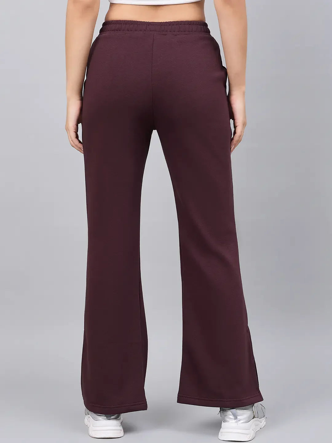 Model wears 98degreenorth Women’s Dark Wine Bootcut Sweatpants with side slit, shown from the back on gray background.