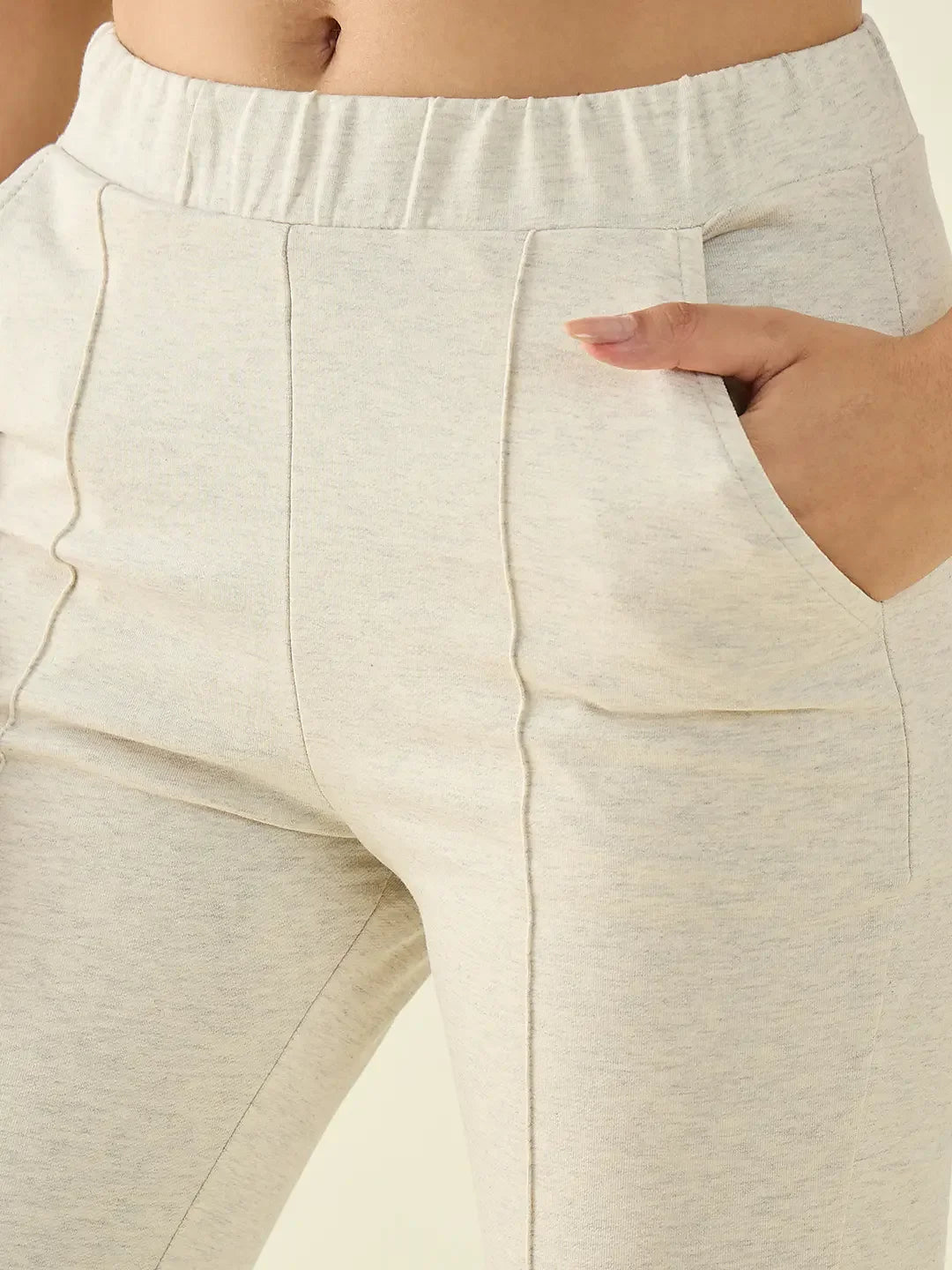 A close-up of a person wearing 98degreenorth Women’s Ecru Flared Bootcut Cotton Stretchable Trousers.