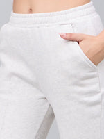 Close-up of a person wearing 98degreenorth Women's Ecru Flared Bootcut Sweatpants with a hand in the pocket.