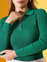 Woman in a 98degreenorth emerald green ribbed collar zipper sweater, standing against a yellow background.