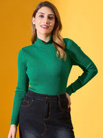 Woman in 98degreenorth emerald green ribbed turtle neck sweater, smiling in black jeans against a yellow background.