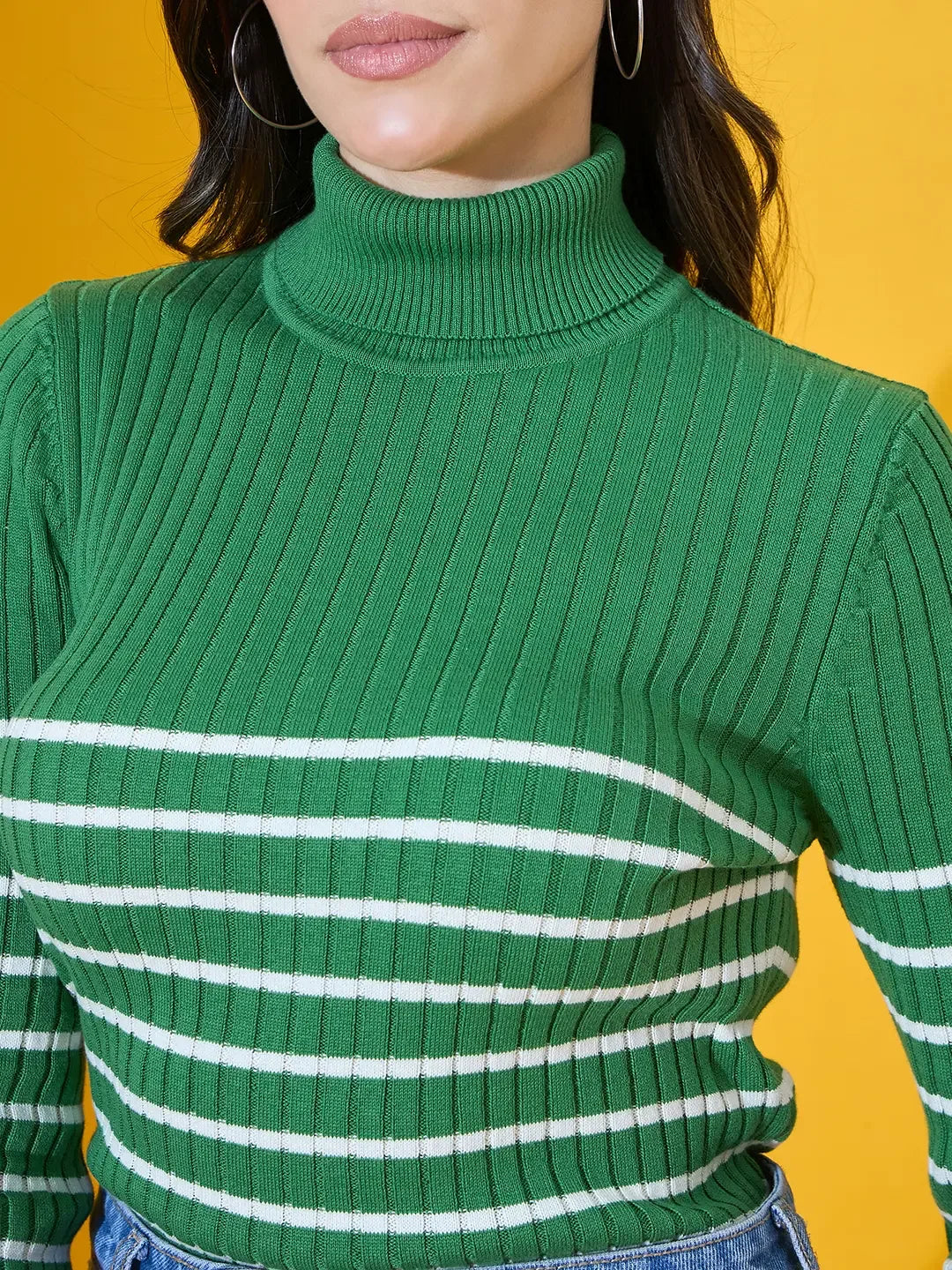 Woman in 98degreenorth’s fern green ribbed knit turtleneck sweater, winter fashion India, against yellow background.