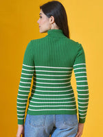 Woman wearing 98degreenorth Fern Green Ribbed Knit Turtleneck Sweater and blue jeans on yellow background.