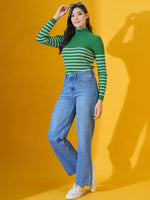 Woman wears 98degreenorth’s fern green ribbed knit turtleneck sweater, posing against a bright yellow background.
