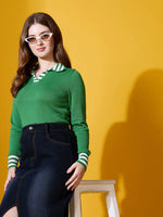 Woman in 98degreenorth Fern Green Striped Collar Knit Sweater and denim skirt poses before a yellow background.