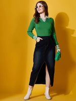 Woman wears 98degreenorth Fern Green Striped Collar Knit Sweater with dark denim skirt and green clutch on yellow background.