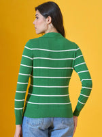 Woman in a 98degreenorth fern green striped collared sweater, blue jeans, facing away against a yellow background.