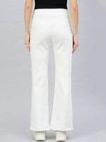 Model wears 98degreenorth Women’s Flared Bootcut Fleece Sweatpants in Off White, shown from the back against gray.