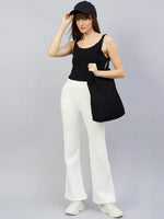 Woman wearing 98degreenorth Women’s Flared Bootcut Fleece Sweatpants in Off White, styled for minimal winter streetwear.