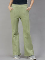 Model wears 98degreenorth Women’s Flared Bootcut Fleece Sweatpants in Pista Melange with black top, silver sneakers.