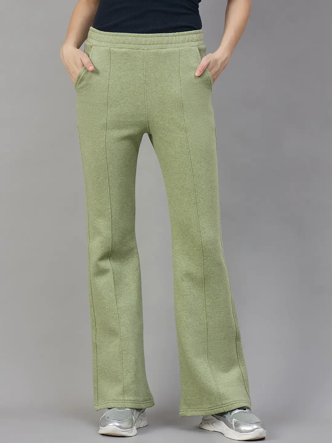 Model wears 98degreenorth Women’s Flared Bootcut Fleece Sweatpants in Pista Melange with black top, silver sneakers.