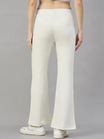 A woman in 98degreenorth Butter Yellow Flared Sweatpants, seen from the back, stands out cheerfully against gray.