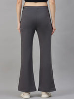 Model wears 98degreenorth Women’s Flared Sweatpants in Charcoal Grey fleece and white sneakers, shown from the back.