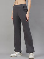 Model wears 98degreenorth Women’s Flared Sweatpants in Charcoal Grey with white sneakers against a gray backdrop.