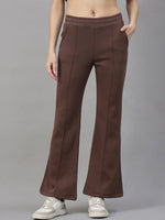Model wears 98degreenorth Women’s Flared Sweatpants in Cocoa Brown, premium fleece, with white sneakers against a grey backdrop.