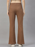 Model wears 98degreenorth Women’s Flared Sweatpants in Coffee Melange, shown from the back against a gray background.