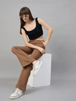 Woman in sunglasses rocks 98degreenorth Women’s Flared Sweatpants in Coffee Melange and a black crop top.