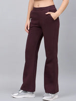 Model wears 98degreenorth Women’s Flared Sweatpants in Dark Wine with pockets, paired with silver sneakers.