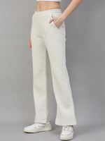 Model in 98degreenorth Women’s Flared Sweatpants in Ecru Off White, styled with sneakers and a crop top.