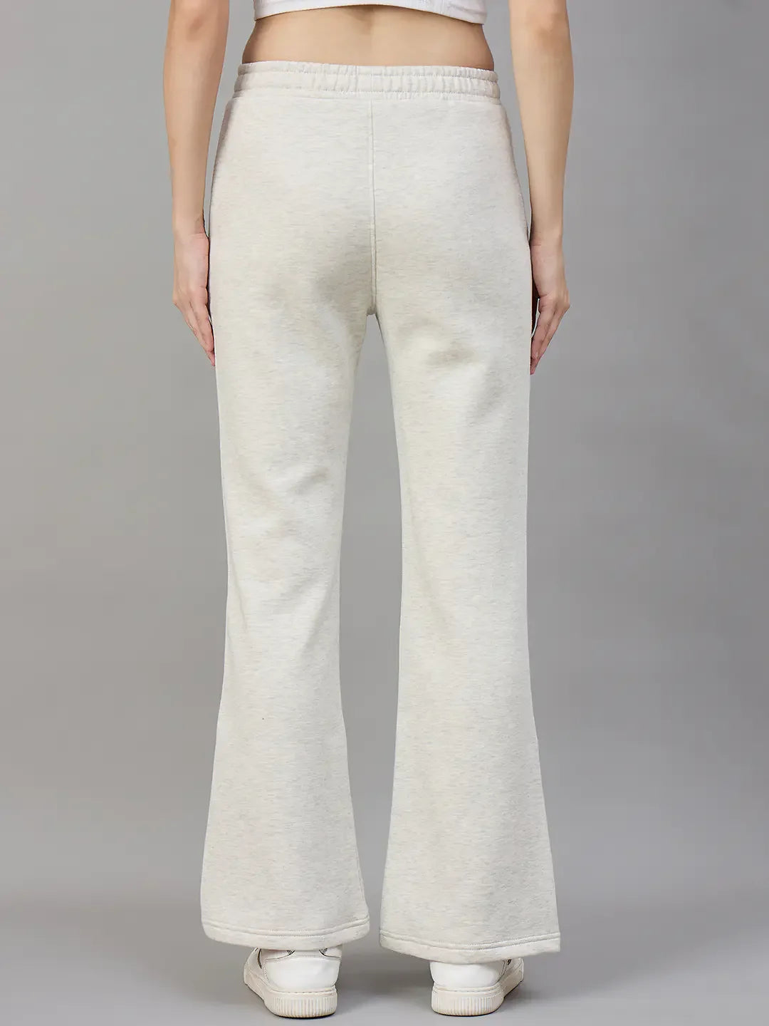 Model wears 98degreenorth Women’s Flared Sweatpants in Ecru Off White, shown from the back against a plain background.