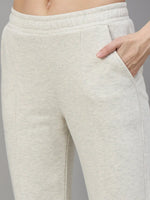 Model wears 98degreenorth Women’s Flared Sweatpants in Ecru Off White, hand in pocket, waist-to-thigh view.