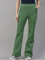 Model wears 98degreenorth Women’s Flared Sweatpants in Hunter Green—cozy winter streetwear—against a gray backdrop.