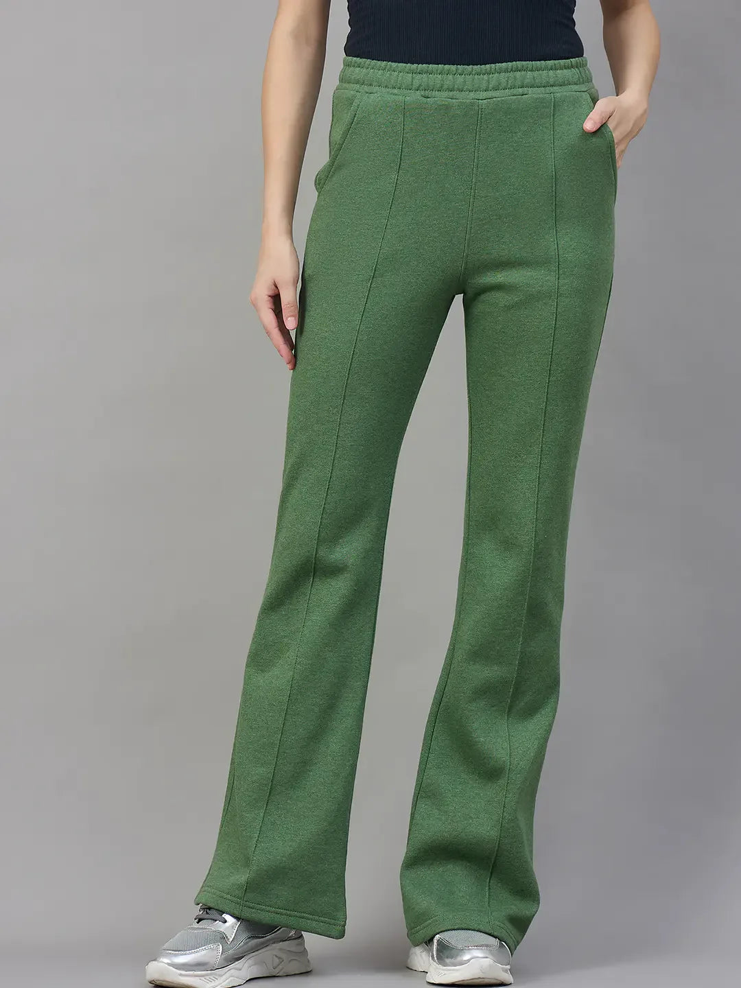 Model wears 98degreenorth Women’s Flared Sweatpants in Hunter Green—cozy winter streetwear—against a gray backdrop.