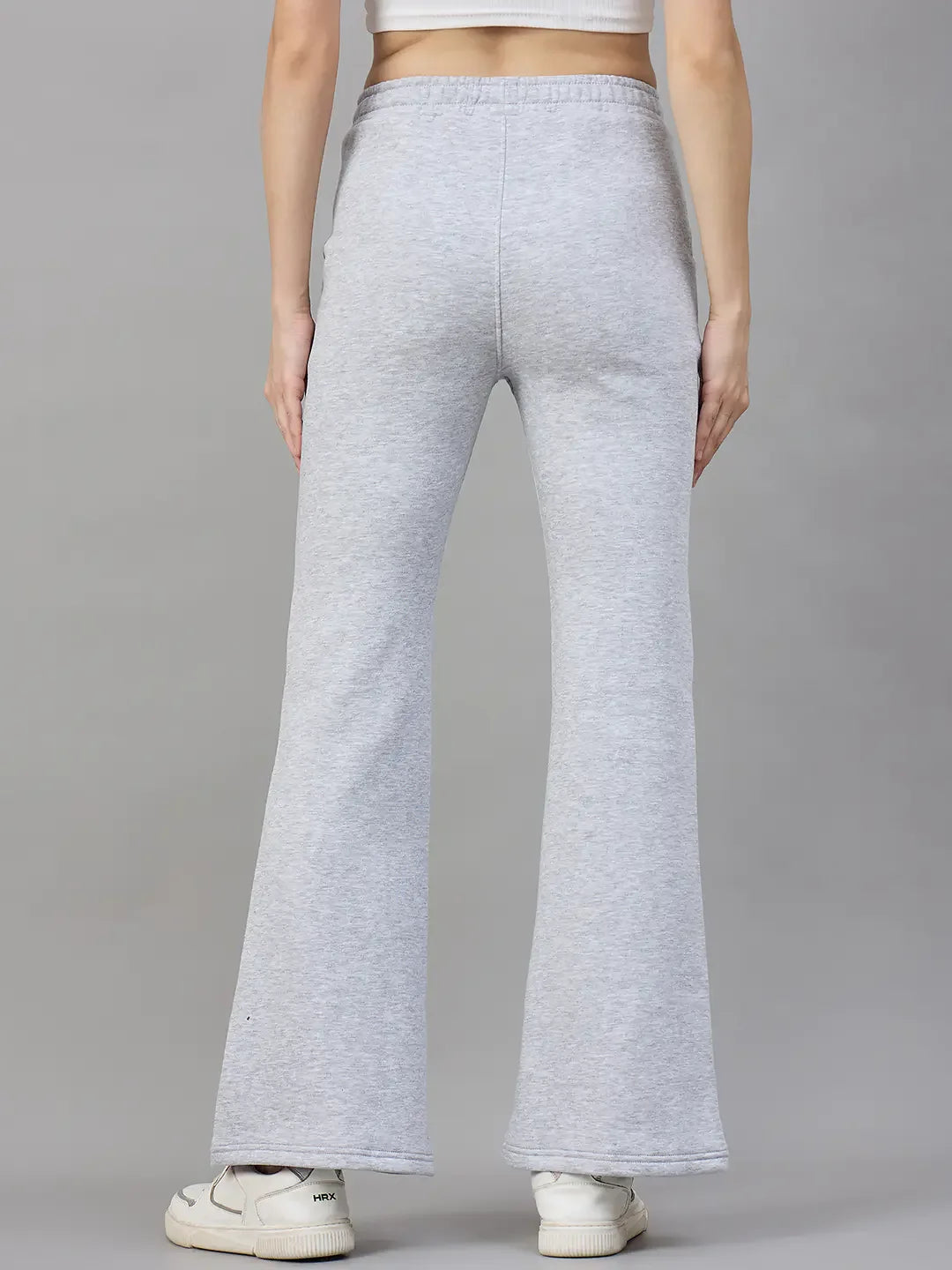 Model wears 98degreenorth Women’s Flared Sweatpants in Light Grey, classic soft fleece winter loungewear with sneakers.