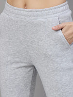 A woman wears 98degreenorth’s Women’s Flared Sweatpants in Light Grey—classic soft fleece for winter loungewear.