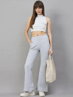 Woman in 98degreenorth’s Light Grey Classic Soft Fleece Flared Sweatpants—perfect winter loungewear.