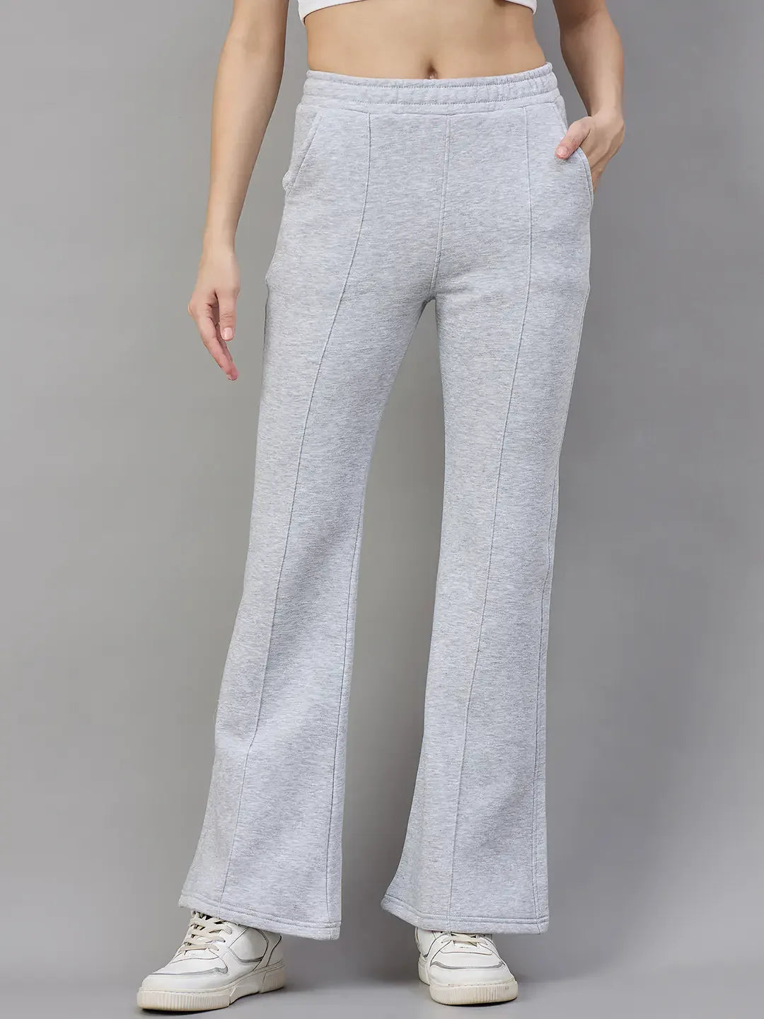 Woman in 98degreenorth Women’s Flared Sweatpants in Light Grey, classic soft fleece—perfect winter loungewear.