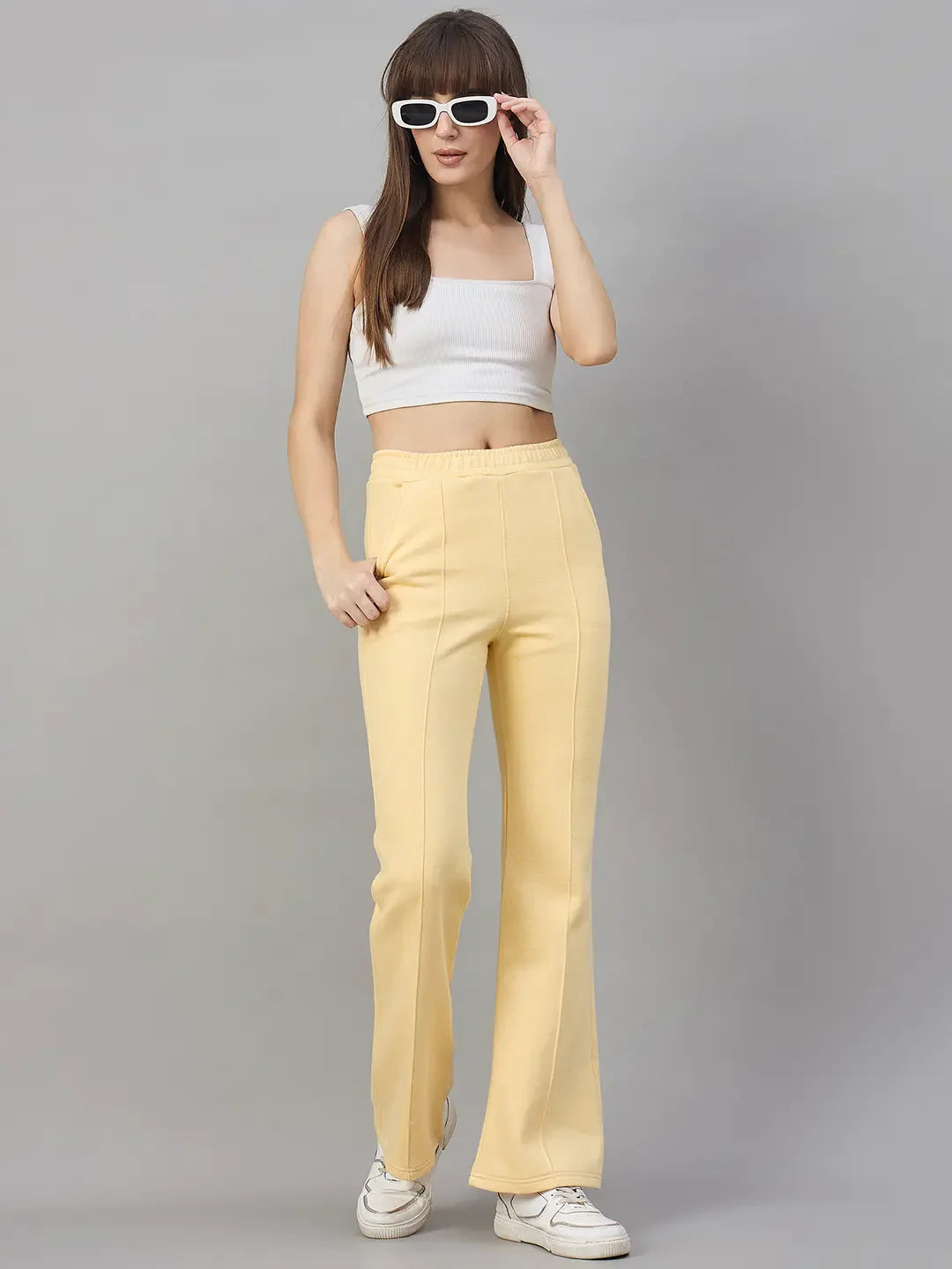 A woman models 98degreenorth’s Mango Melange Flared Sweatpants—trendy winter wear for women.