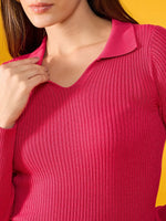 Close-up of a woman in a 98degreenorth fuchsia pink ribbed collar sweater, set against a vibrant yellow background.