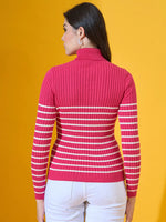 Woman in 98degreenorth’s fuchsia ribbed knit turtleneck sweater stands against a yellow background, facing away.