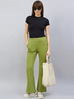 Woman in black tee, 98degreenorth Women’s Green Flared Bootcut Sweatpants, sunglasses, sneakers, and beige tote bag.