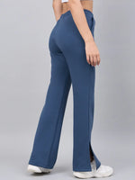 Model wears 98degreenorth Indigo Blue Bootcut Sweatpants with side slits, paired with white sneakers and a crop top.