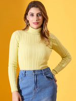 Model in a 98degreenorth Women’s Lemon Ribbed Turtleneck Sweater pairs it with blue jeans against a yellow backdrop.