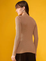 A woman wears a 98degreenorth Light Camel Ribbed Turtle Neck Sweater with black pants, facing away on a yellow background.