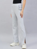 Person in 98degreenorth Women’s Light Grey Bootcut Sweatpants, flared side-slit lounge pants, with white sneakers.
