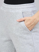 Model wears 98degreenorth Women’s Light Grey Bootcut Sweatpants with one hand in pocket, shown waist down.