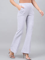Woman in 98degreenorth Light Grey Flared Bootcut Cotton Stretchable Trousers, standing against a plain grey background.