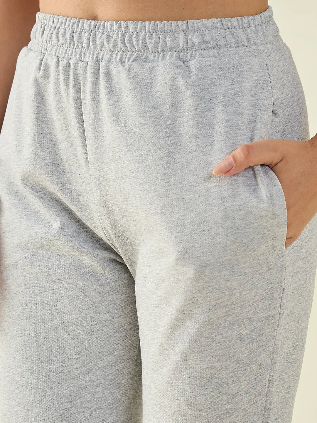 Person wearing 98degreenorth Women’s Light Grey Regular Fit Cotton Stretchable Trousers with an elastic waistband.