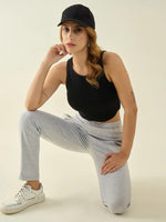 Woman in a black tank top wears 98degreenorth Women’s Light Grey Regular Fit Cotton Stretchable Trousers.