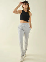 Woman wears 98degreenorth Women’s Light Grey Regular Fit Cotton Stretchable Trousers, posing against a plain background.