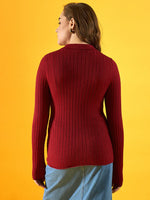 A woman in a 98degreenorth maroon ribbed collar neck sweater and blue denim skirt stands against a yellow background.