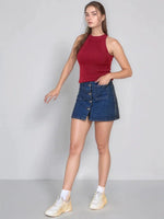 Woman wears 98degreenorth Women’s Maroon Ribbed Halter Neck Sleeveless Knit Top with denim skirt, white socks, and sneakers.