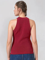 Woman in a 98degreenorth maroon ribbed halter neck slim fit knit top and blue jeans, shown from the back.