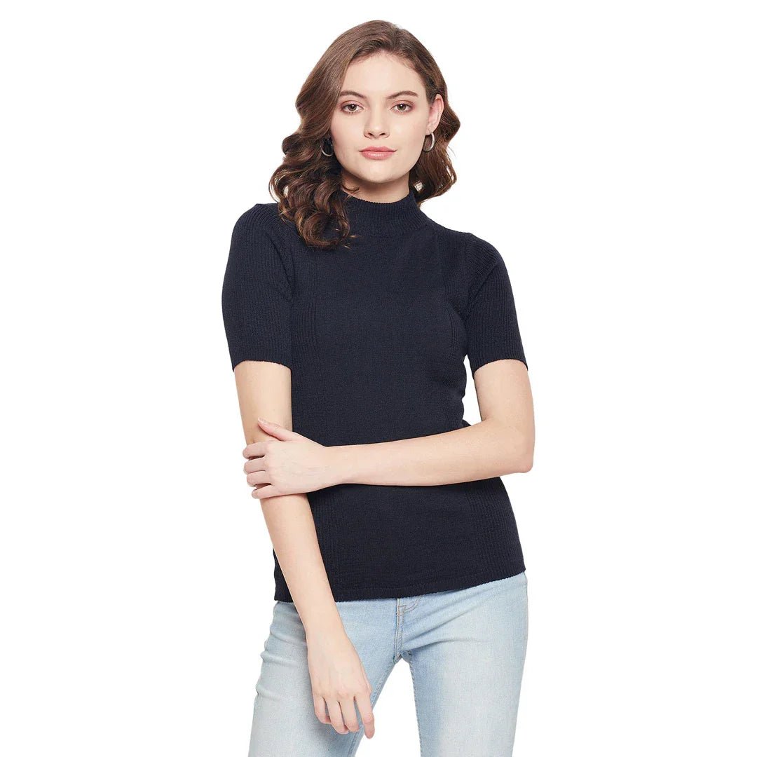 Woman in 98degreenorth navy blue ribbed turtle neck slim fit sweater and light blue jeans, against a white background.